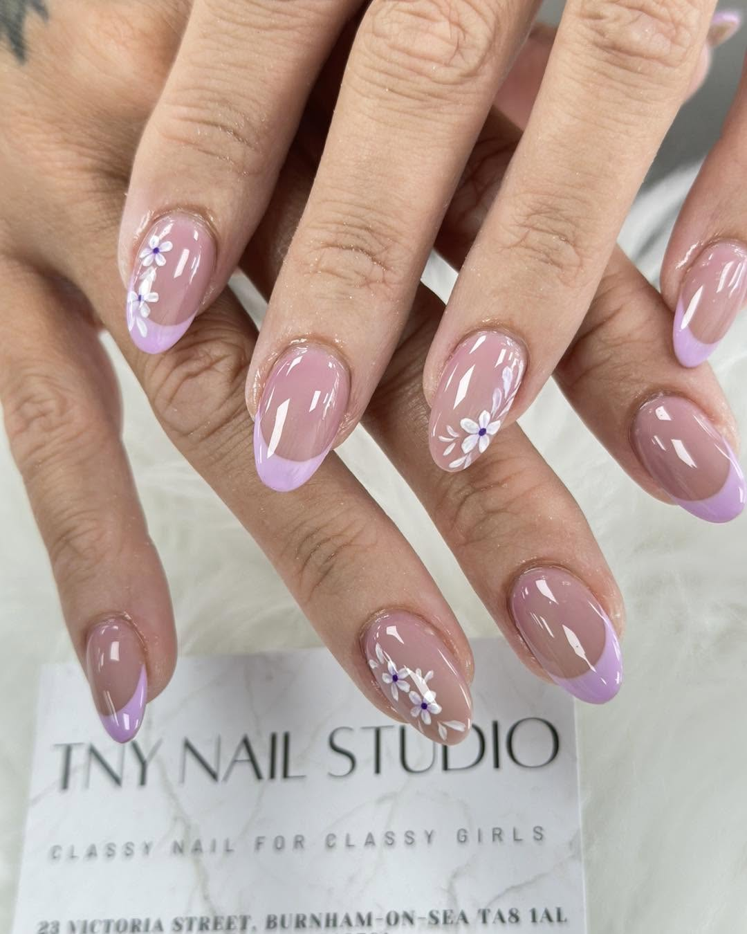 Lilac French manicure with daisy details